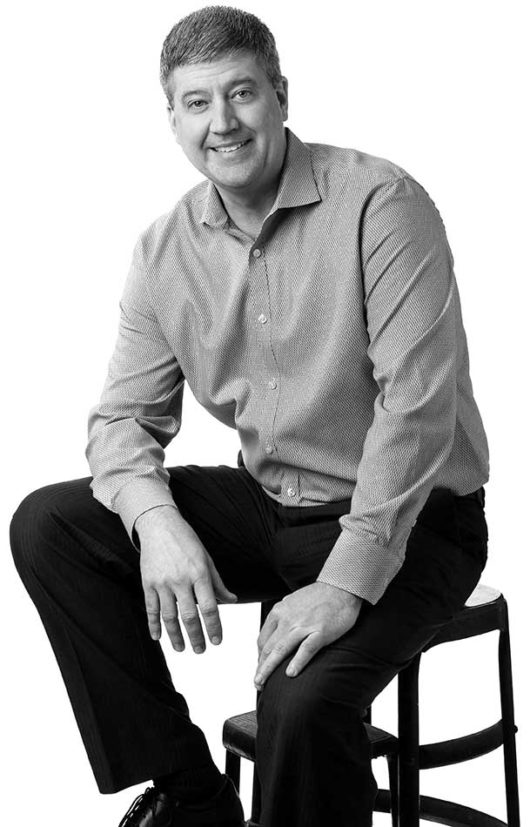 Shawn Burcham seated on chair